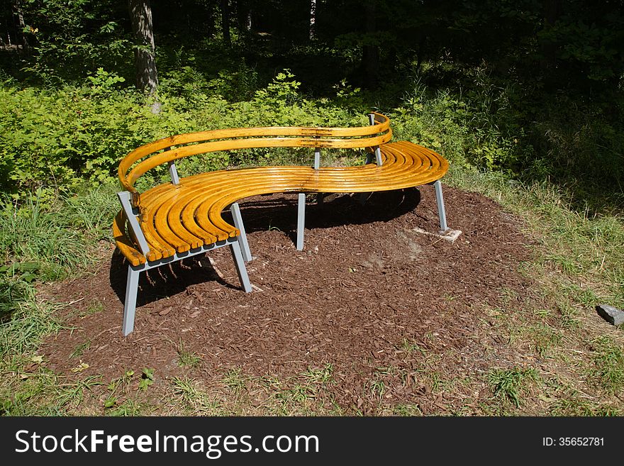 S-Shaped park bench in the woods