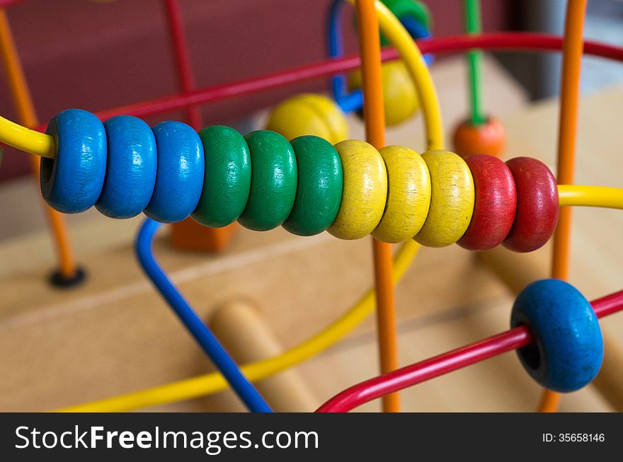 Wooden toy of colorful rings, close up.