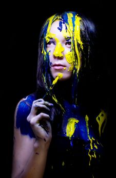 Beauty/fashion Close Up Portrait Of Woman Painted Blue And Yellow With Brushes And Paint  On Black Background Royalty Free Stock Photography