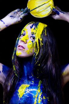 Beauty/fashion Close Up Portrait Of Woman Painted Blue And Yellow With Brushes And Paint  On Black Background Royalty Free Stock Image