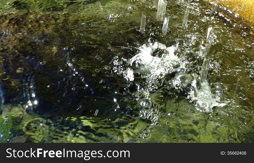 Waterfall Splashing Into a Pond