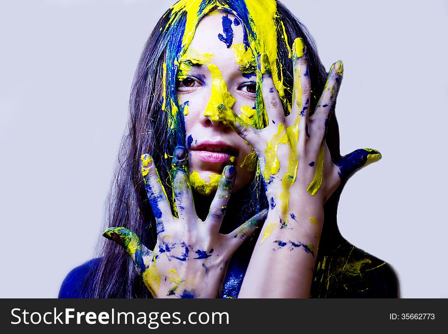 Beauty/fashion Close Up Portrait Of Woman Painted Blue And Yellow On White Background