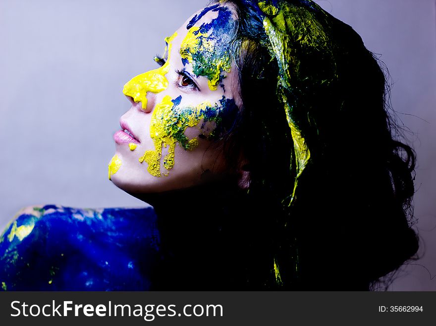 Beauty/fashion Close Up Portrait Of Woman Painted Blue And Yellow On White Background