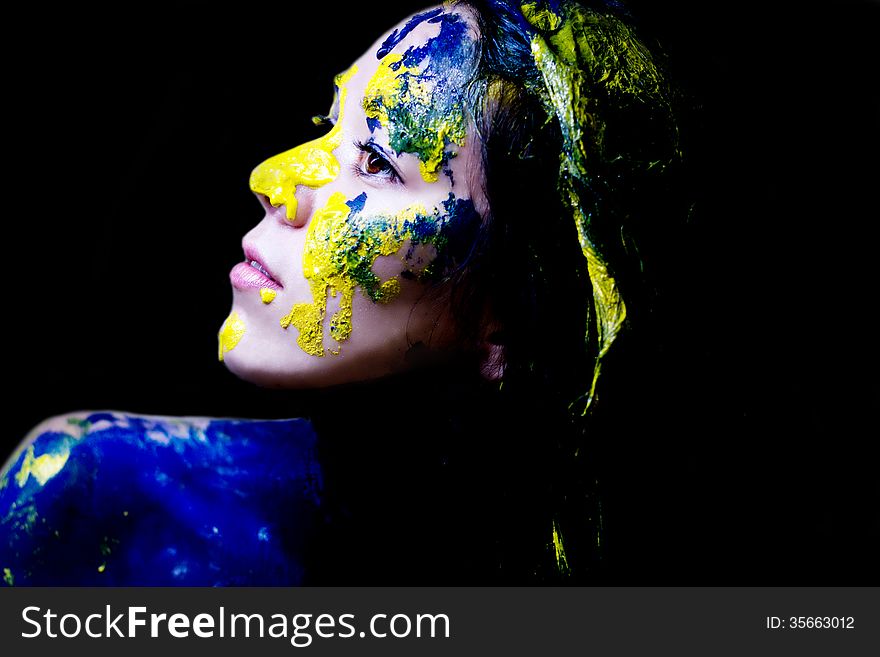 Beauty/fashion Close Up Portrait Of Woman Painted Blue And Yellow On Black Background