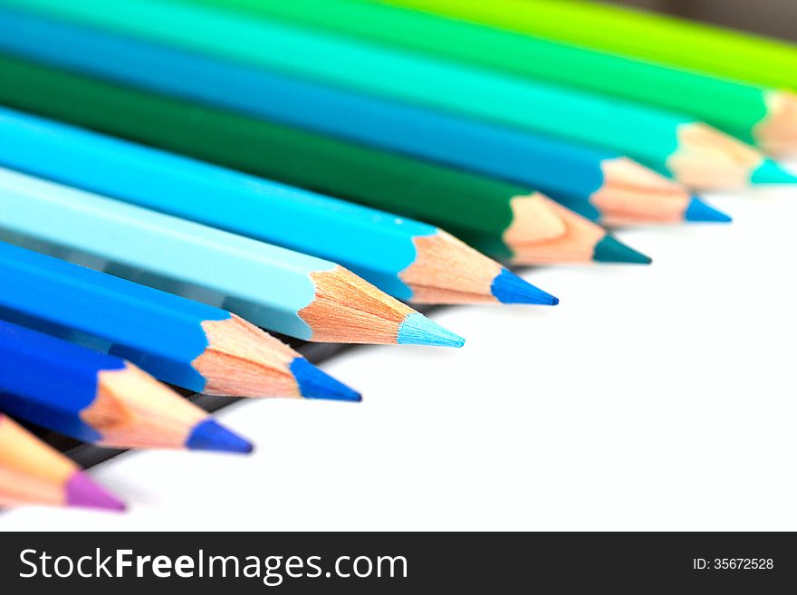 A group of colourful colour pencils lined up side by side