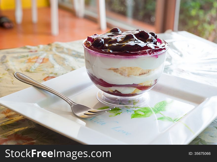 Fancy blueberry cake in white dish .