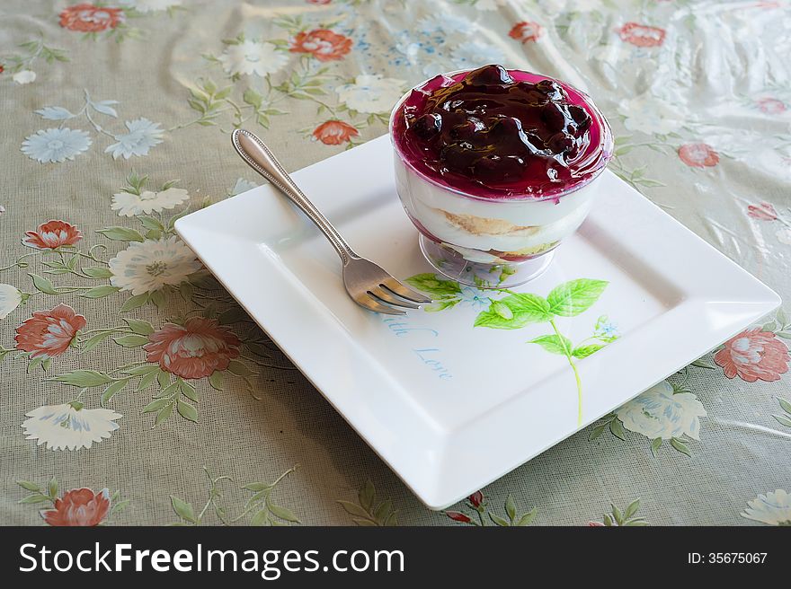 Fancy blueberry cake in white dish .