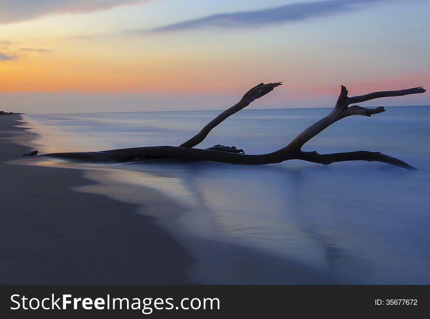 A sunset beach, nature and water