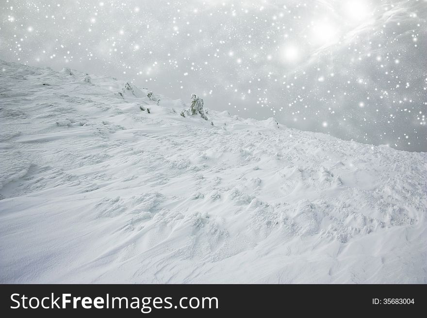 Christmas background with snow covered hillside