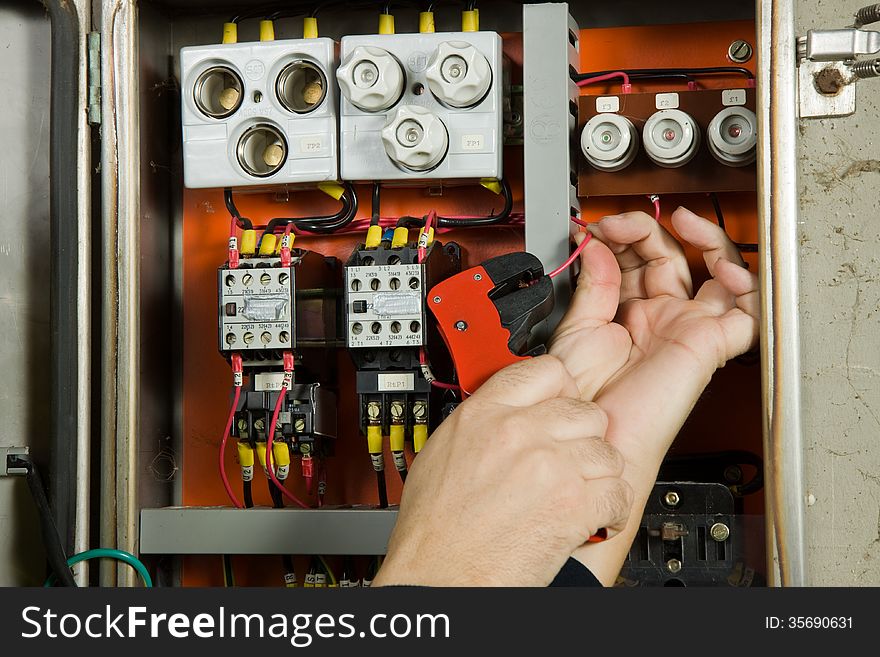 Electrician working in a plant to be fitted