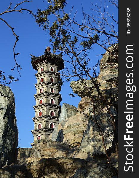 The China pagoda on the artificial hill with the blue sky. The China pagoda on the artificial hill with the blue sky