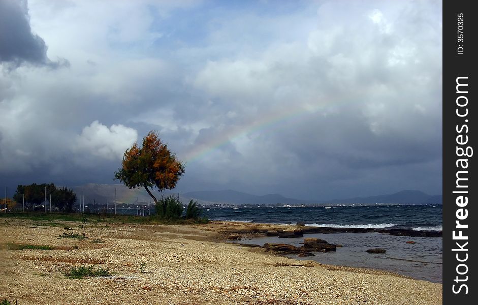 A rainbow at the stormy sky by the seaside winter time. A rainbow at the stormy sky by the seaside winter time