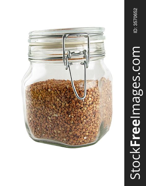 Glass container with buckwheat isolated on white. Glass container with buckwheat isolated on white