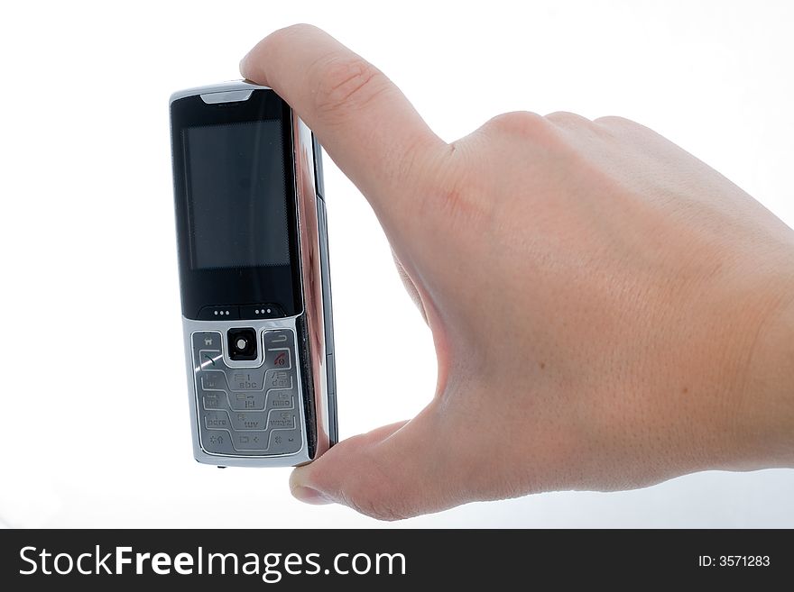 Small Silver Mobile Phone Device in hand. Small Silver Mobile Phone Device in hand