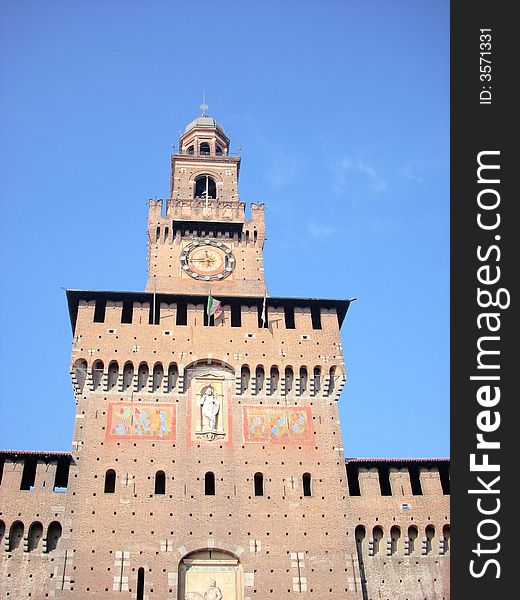 The bell tower of the castle sforzesco in Milan under a blue sky in autumn