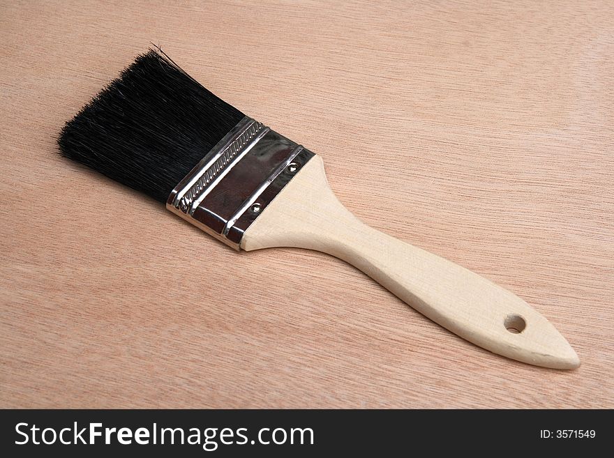 New paint brush on unpainted wood background. New paint brush on unpainted wood background.