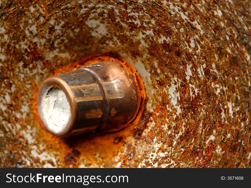 Bullet stuck in rusty metal