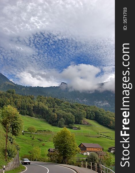 Road, placed in Switzerland Alps between green meadows. Road, placed in Switzerland Alps between green meadows.