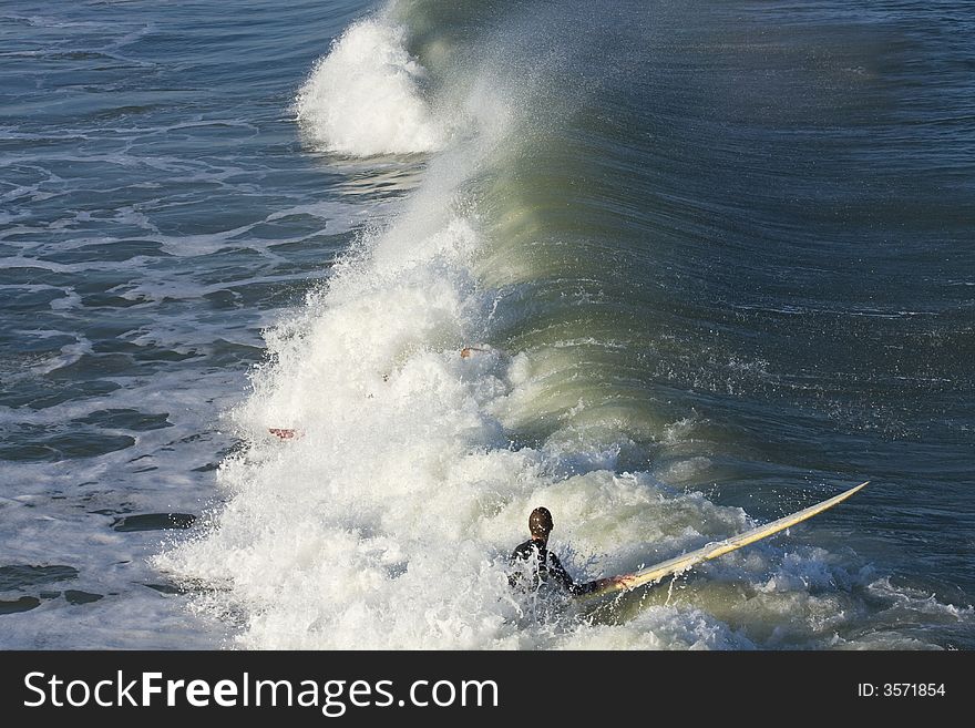 Surfers practicing ridng the waves,colorful waters. Surfers practicing ridng the waves,colorful waters