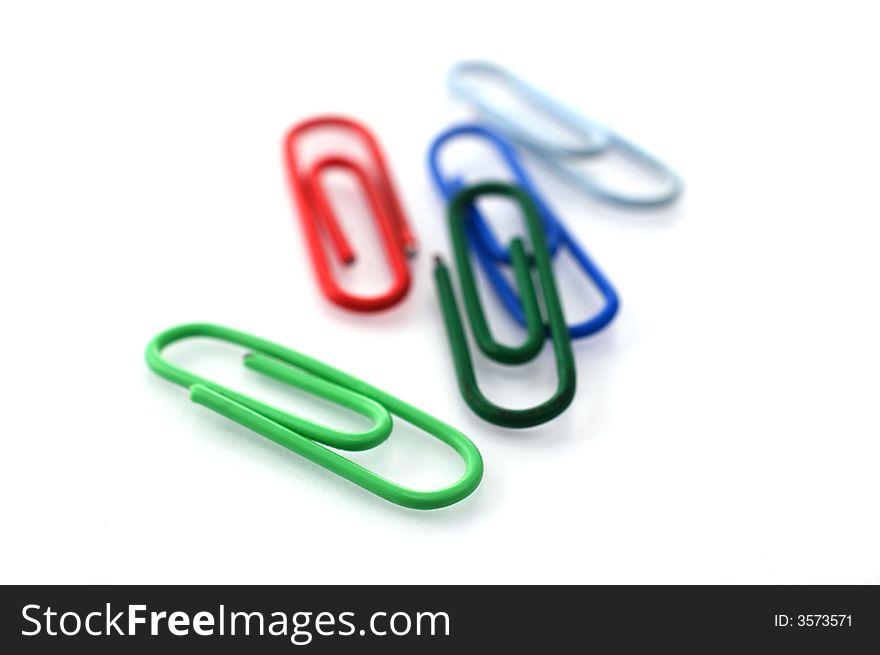 Colored paper clips isolated on white with shallow depth of field. Colored paper clips isolated on white with shallow depth of field