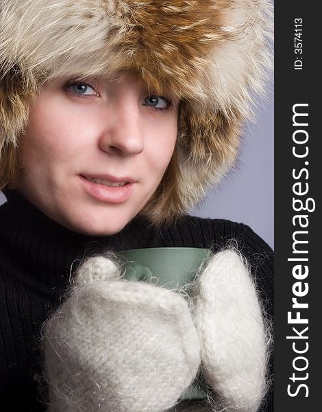 Pretty woman in winter hat with cup. Pretty woman in winter hat with cup