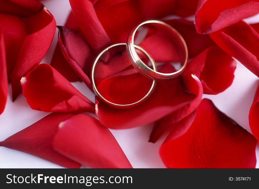 Two gold rings with red roses.