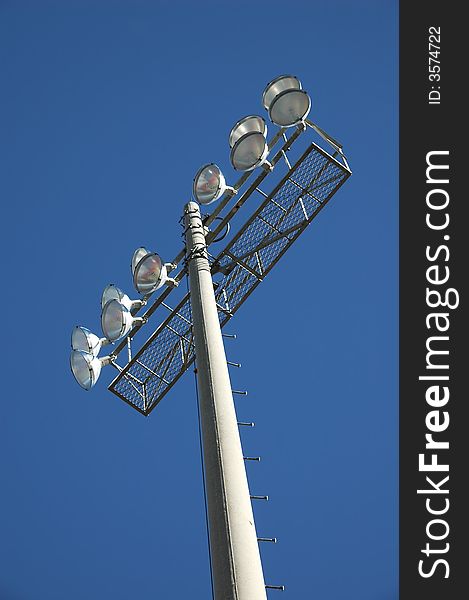 Stadium lights isolated against a blue sky