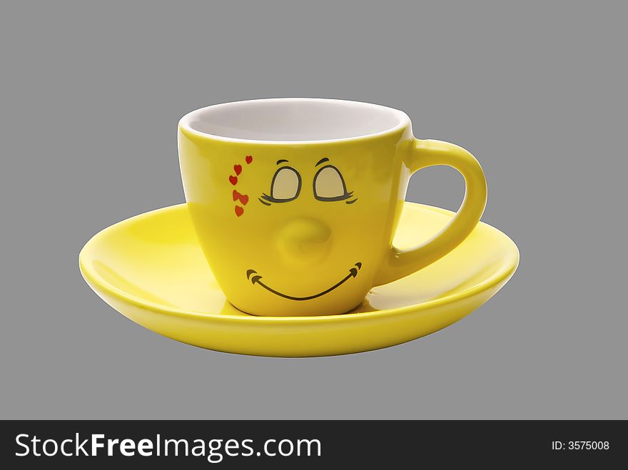 Ridiculous yellow coffee cup with a smile and heart. Ridiculous yellow coffee cup with a smile and heart