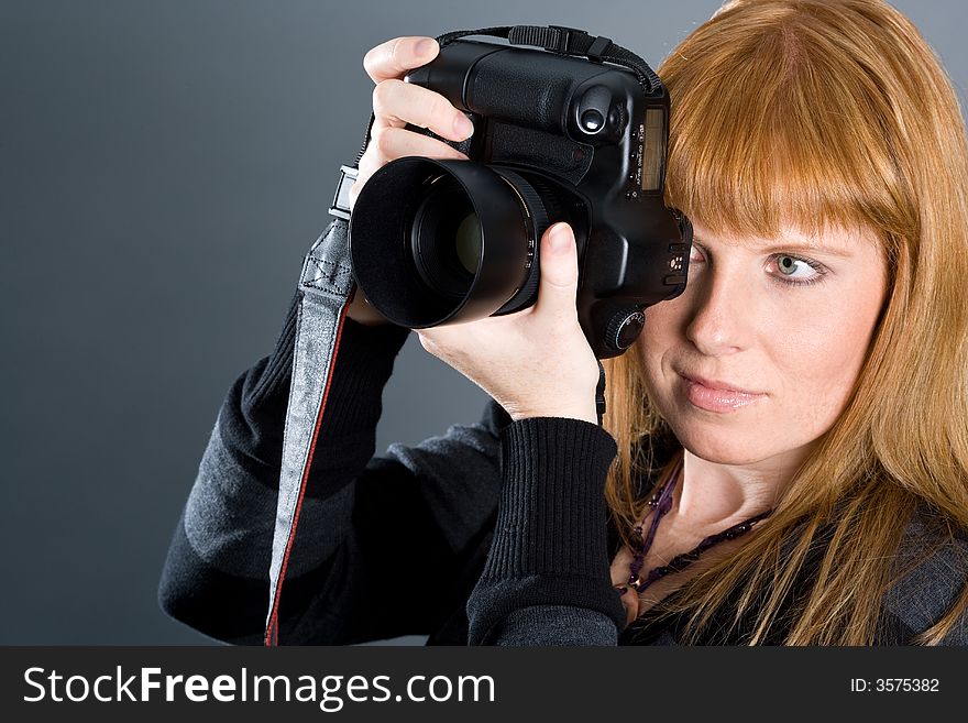 Woman photographing with professional camera.