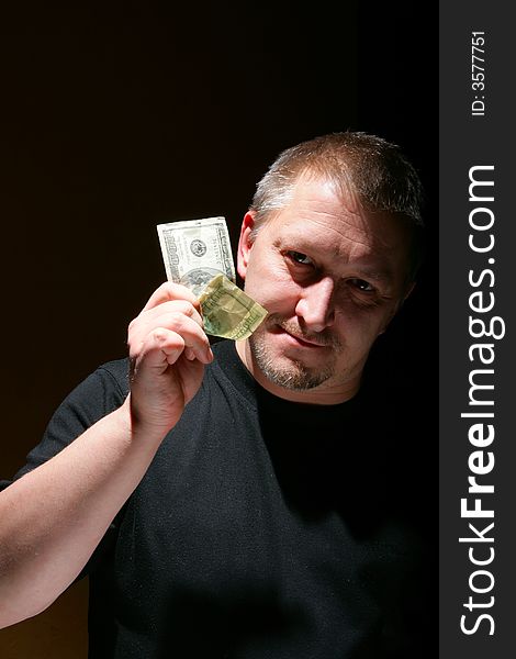 Man offering money over black background with space for your own text above and  below.