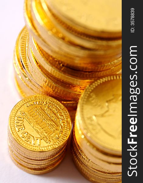 Close-up of gold foil-covered chocolate coins, focusing on a one cent coin