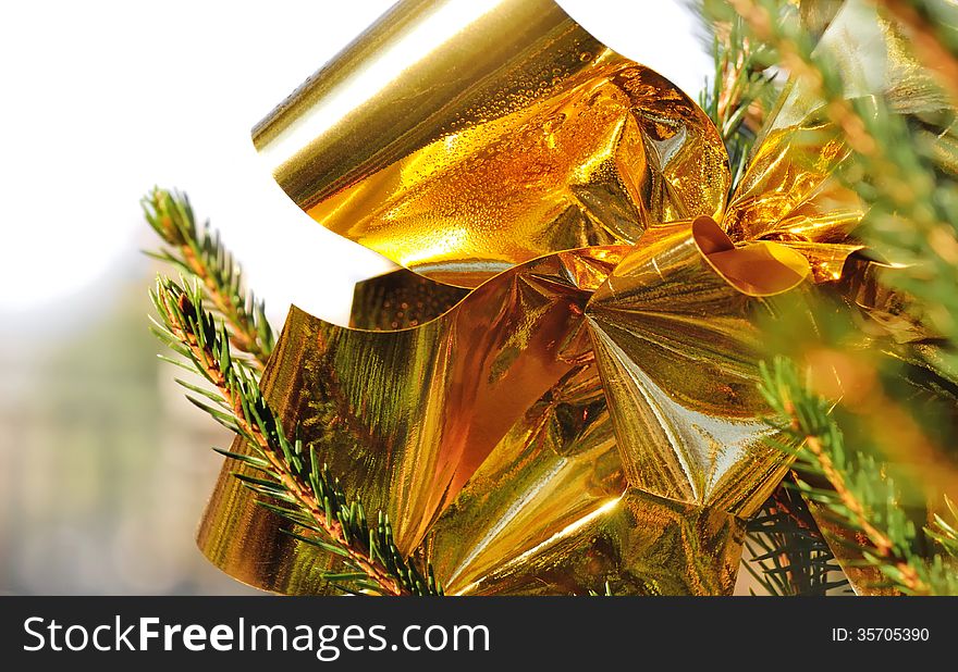 Close on glossy golden ribbon on a Christmas tree