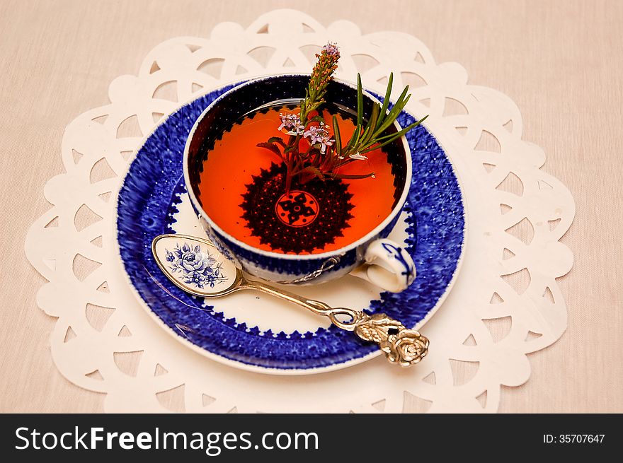 Rooibos or red bush tea with a sprig of herbs in a beautiful blue and white antique china teacup. Rooibos or red bush tea with a sprig of herbs in a beautiful blue and white antique china teacup.