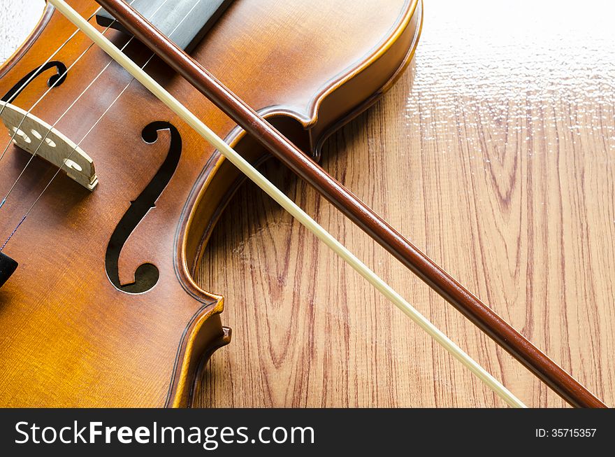 String instrument violin on wood background