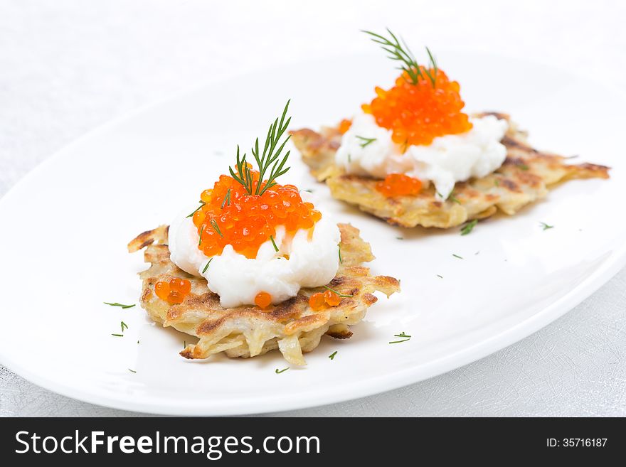 Potato pancakes with caviar, close-up, horizontal