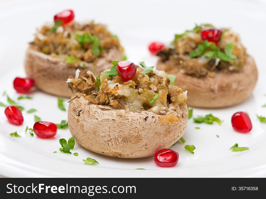 Stuffed mushrooms with herbs and pomegranate, close-up