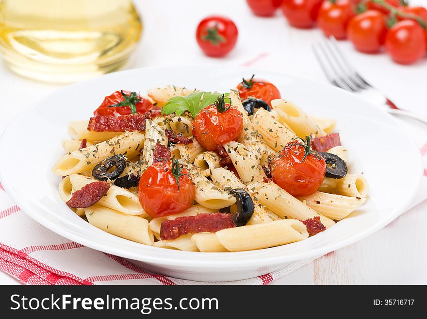 Pasta With Sausage, Cherry Tomatoes And Olives On The Plate