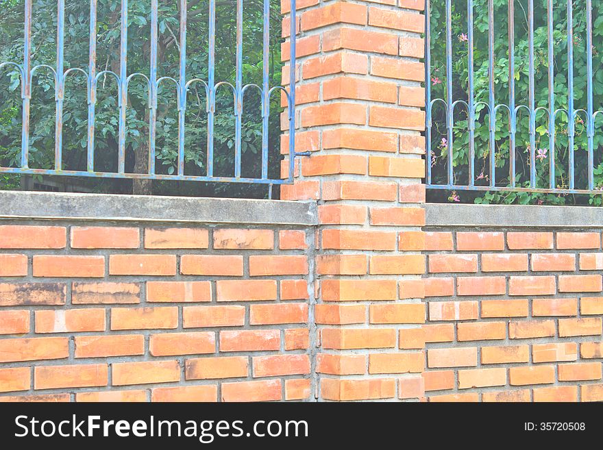 Old Brick Wall and Iron Fence on Top of it