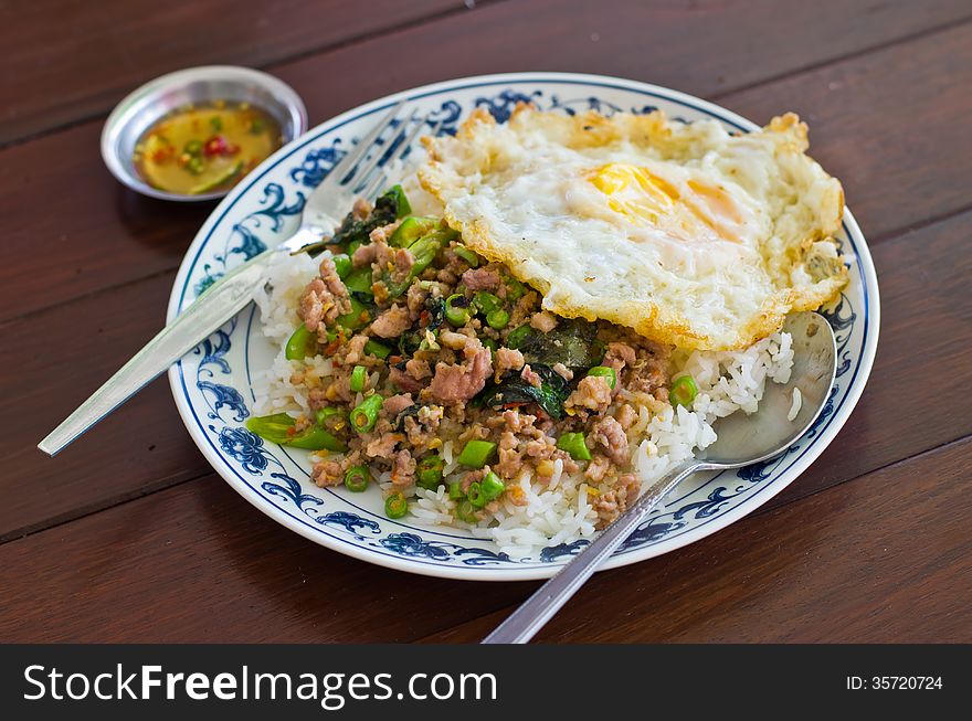Stir fried pork with basil and egg on rice,Thai popular menu