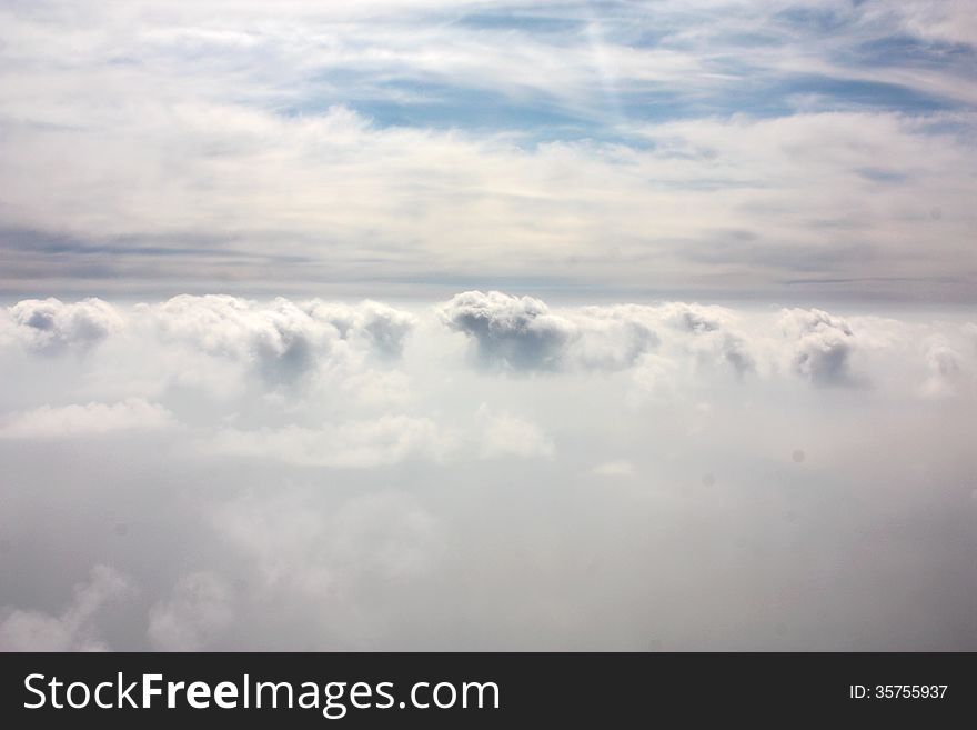 On a plane travel to Shenzhen, the plane triumph in the sky above the clouds. On a plane travel to Shenzhen, the plane triumph in the sky above the clouds