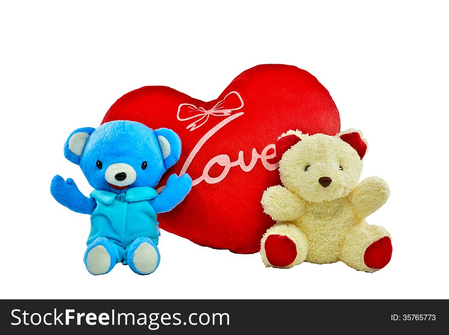 Blue and cream colour bears with red heart pillow on white background