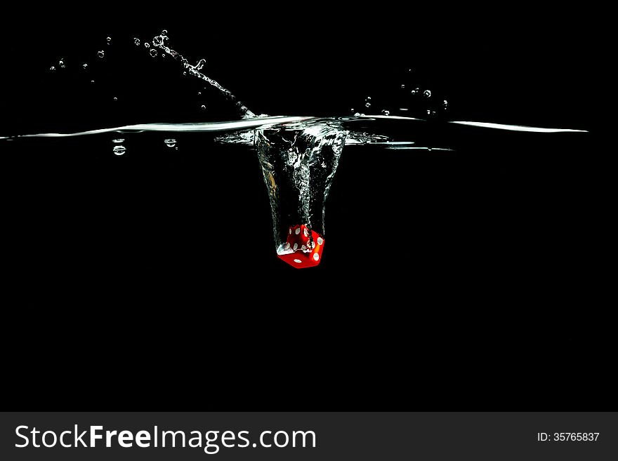 Red splashing dice on black background