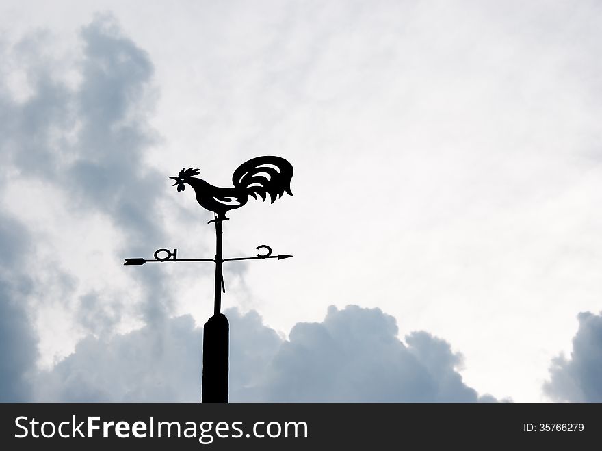 Weather vane against the evening sky and clouds. Weather vane against the evening sky and clouds