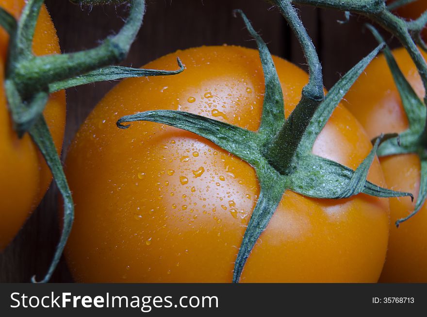 Fresh juicy orange tomatoes closeup