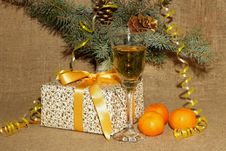 A Glass Of Champagne, Tangerines And Present For The New Year Stock Images A Glass Of Champagne, Tangerines And Present For The New Year Stock Images