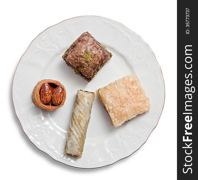 Plate with various turkish baklava isolated over white background