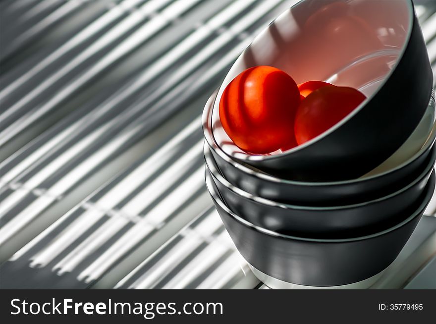 Plates stacked on the table three tomatoes