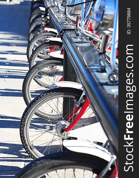 Few bicycles for rent in a row on street parking. Few bicycles for rent in a row on street parking