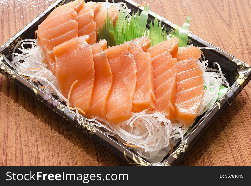 Fresh salmon piece for sushi on wood background. Fresh salmon piece for sushi on wood background