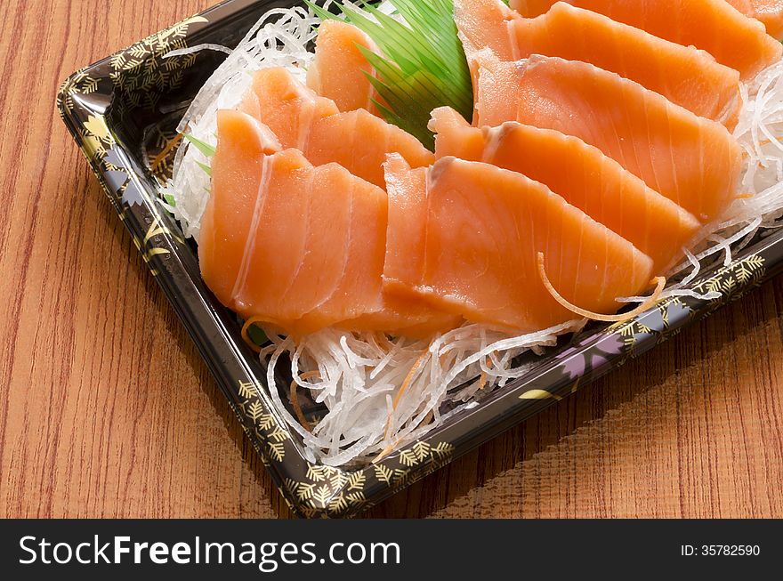 Fresh salmon piece for sushi on wood background. Fresh salmon piece for sushi on wood background